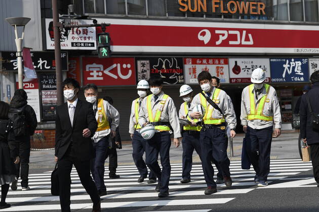 TOKYO, JAPAN - APRIL 17: Commuters wearing face mask head to work early morning in Shinjuku, Tokyo on Friday, April 17, 2020. The Japanese government decided to expand the current areas under a state of emergency to nationwide, as the Covid-19 coronavirus outbreak continues to spread throughout the country. (Photo: Richard Atrero de Guzman AFLO) (125423298)
