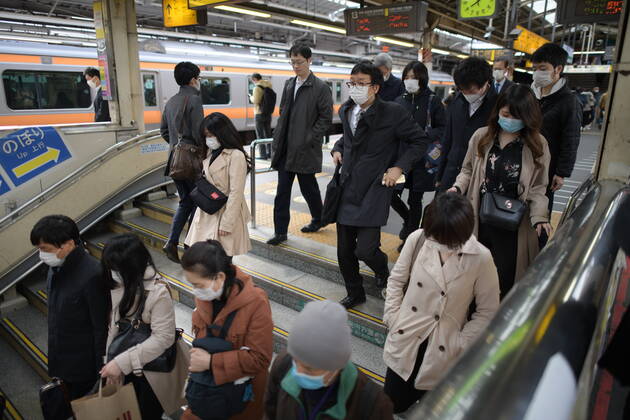TOKYO, JAPAN - APRIL 17: Commuters wearing face mask head to work early morning in Shinjuku Station, Tokyo on Friday, April 17, 2020. The Japanese government decided to expand the current areas under a state of emergency to nationwide, as the Covid-19 coronavirus outbreak continues to spread throughout the country. (Photo: Richard Atrero de Guzman AFLO) (125423438)