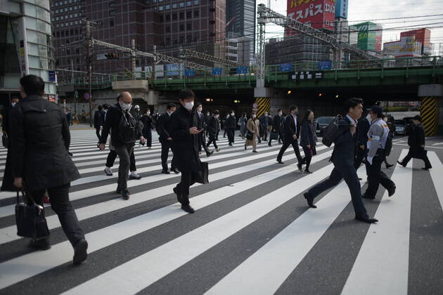 TOKYO, JAPAN - APRIL 17: Commuters wearing face mask head to work early morning in Shinjuku, Tokyo on Friday, April 17, 2020. The Japanese government decided to expand the current areas under a state of emergency to nationwide, as the Covid-19 coronavirus outbreak continues to spread throughout the country. (Photo: Richard Atrero de Guzman AFLO) (125423642)