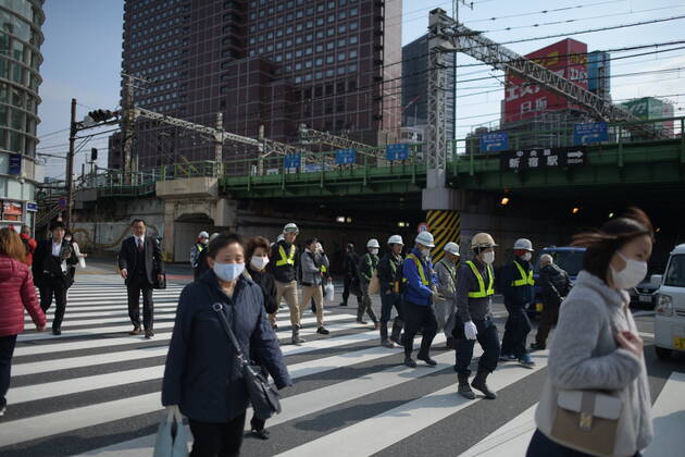 TOKYO, JAPAN - APRIL 17: Commuters wearing face mask head to work early morning in Shinjuku, Tokyo on Friday, April 17, 2020. The Japanese government decided to expand the current areas under a state of emergency to nationwide, as the Covid-19 coronavirus outbreak continues to spread throughout the country. (Photo: Richard Atrero de Guzman AFLO) (125423692)
