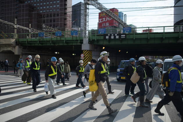 TOKYO, JAPAN - APRIL 17: Commuters wearing face mask head to work early morning in Shinjuku, Tokyo on Friday, April 17, 2020. The Japanese government decided to expand the current areas under a state of emergency to nationwide, as the Covid-19 coronavirus outbreak continues to spread throughout the country. (Photo: Richard Atrero de Guzman AFLO) (125423696)