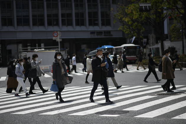 TOKYO, JAPAN - APRIL 17: Commuters wearing face mask walks in near JR Shibuya Station in Tokyo on Friday, April 17, 2020. The Japanese government decided to expand the current areas under a state of emergency to nationwide, as the Covid-19 coronavirus outbreak continues to spread throughout the country. (Photo: Richard Atrero de Guzman AFLO) (125429982)