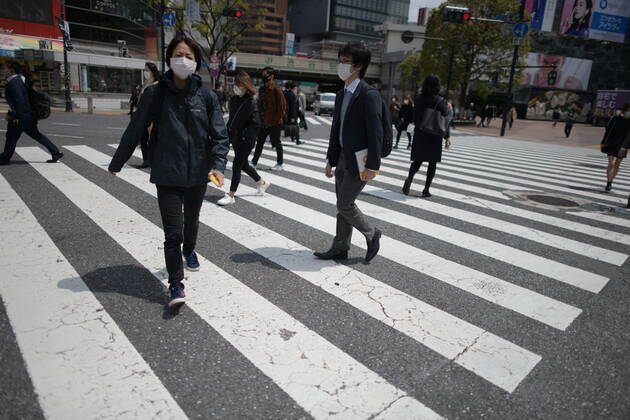 TOKYO, JAPAN - APRIL 17: Commuters wearing face mask walks in near JR Shibuya Station in Tokyo on Friday, April 17, 2020. The Japanese government decided to expand the current areas under a state of emergency to nationwide, as the Covid-19 coronavirus outbreak continues to spread throughout the country. (Photo: Richard Atrero de Guzman AFLO) (125430359)