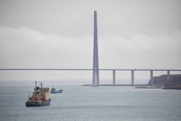 VLADIVOSTOK, RUSSIA - APRIL 17, 2020: A distant view of Russky Bridge over the Eastern Bosphorus Strait between mainland Vladivostok and Russky Island in Russia s Far East during the pandemic of the novel coronvirus disease (COVID-19). Vladivostok s traffic police have set up a checkpoint at the approach to the bridge to stop vehicles and see if drivers and cyclists have permission to travel to Russky Island during the lockdown. Vladivostok s authorities have restricted access to Russky Island and a few smaller islands -- popular weekend retreats -- to prevent people from violating lockdown measures. Only those who live, work or study on the islands are allowed to travel. Since 31 March 2020, the Primorye Territory, including Vladivostok, has been on lockdown to counter the spread of the infection. As of 17 April 2020, the Primorye Terri  TS0D6124