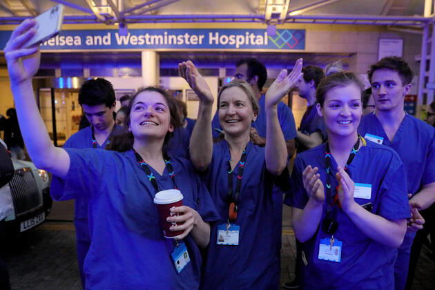 (200417) -- LONDON, April 17, 2020 (Xinhua) -- Medical workers applaud outside Chelsea and Westminster Hospital during the weekly clap for the NHS (National Health Service) in London, Britain on April 16, 2020. (Photo by Tim Ireland Xinhua) BRITAIN-LONDON-COVID-19-NHS-CLAPPING 