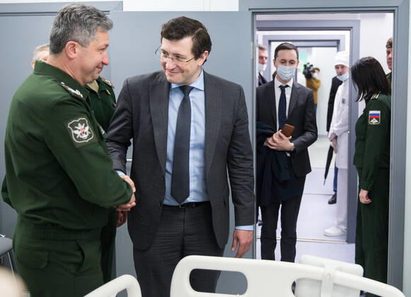 NIZHNY NOVGOROD, RUSSIA - APRIL 17, 2020: Russia s Deputy Minister of Defence Timur Ivanov (L) and Nizhny Novgorod Region Governor Gleb Nikitin shake hands during the opening ceremony of a multipurpose medical centre for coronavirus patients constructed at army hospital No 422 of the Russian Defence Ministry; the Russian Defence Ministry is building 16 infectious disease centres for COVID-19 patients in various Russian cities; the centres under construction in Odintsovo, Podolsk, Volgograd, Novosibirsk, Orenburg, Ulan-Ude, and Ussuriysk are slated for completion by the end of April. Mikhail Solunin TASS  TS0D61B4