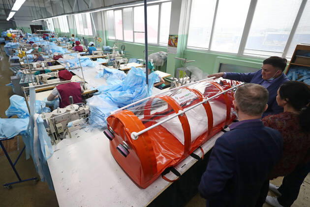 TATARSTAN, RUSSIA - APRIL 17, 2020: Experts of the Tatneft research center developing a protective box for transporting coronavirus patients at the Aznakai Kiemnere clothing factory in the town of Aznakayevo. Tatneft also launched production of medical clothing for infectious diseases physicians working with COVID-19 patients at the factory; protective suits are handed over to Tatarstan s hospitals for free. Yegor Aleyev TASS  TS0D61F9