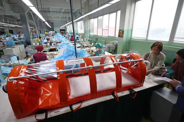 TATARSTAN, RUSSIA - APRIL 17, 2020: Experts of the Tatneft research center developing a protective box for transporting coronavirus patients at the Aznakai Kiemnere clothing factory in the town of Aznakayevo. Tatneft also launched production of medical clothing for infectious diseases physicians working with COVID-19 patients at the factory; protective suits are handed over to Tatarstan s hospitals for free. Yegor Aleyev TASS  TS0D61FA