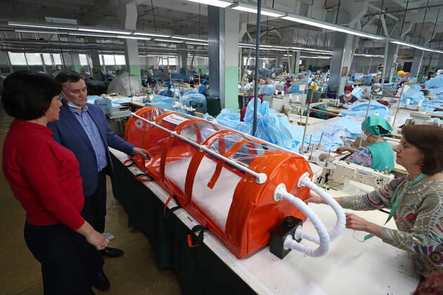 TATARSTAN, RUSSIA - APRIL 17, 2020: Experts of the Tatneft research center developing a protective box for transporting coronavirus patients at the Aznakai Kiemnere clothing factory in the town of Aznakayevo. Tatneft also launched production of medical clothing for infectious diseases physicians working with COVID-19 patients at the factory; protective suits are handed over to Tatarstan s hospitals for free. Yegor Aleyev TASS  TS0D61FC