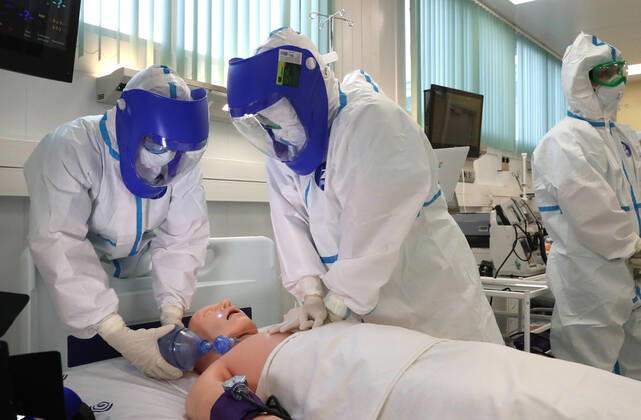MOSCOW, RUSSIA - APRIL 17, 2020: Employees training on a medical simulation mannequin in a new infectious diseases hospital for COVID-19 coronavirus patients in the village of Voronovskoye. Vladimir Gerdo TASS  TS0D6224