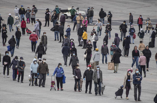 People line up to receive bags of food from the San Francisco-Marin Food Bank in the parking lot of the Cow Palace in Daly City, California on Friday, April 17, 2020. Local food banks have moved into high gear as the Coronavirus has hit the food insecure especially hard.  SXP2020041625 TERRYxSCHMITT
