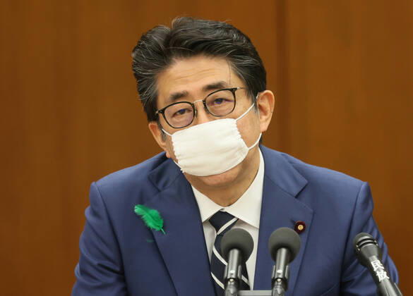 April 17, 2020, Tokyo, Japan - Japanese Prime Minister Shinzo Abe wearing a face mask answers a question at Lower House s health, labour and welfare committee session at the National Diet in Tokyo on Friday, April 17, 2020. Abe expanded a state of emergency across Japan to prevent outbreak of the new coronavirus on April 17.  (125461102)