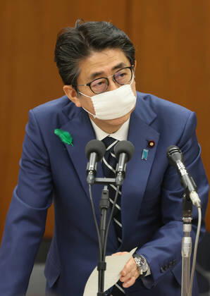 April 17, 2020, Tokyo, Japan - Japanese Prime Minister Shinzo Abe wearing a face mask answers a question at Lower House s health, labour and welfare committee session at the National Diet in Tokyo on Friday, April 17, 2020. Abe expanded a state of emergency across Japan to prevent outbreak of the new coronavirus on April 17.  (125461106)