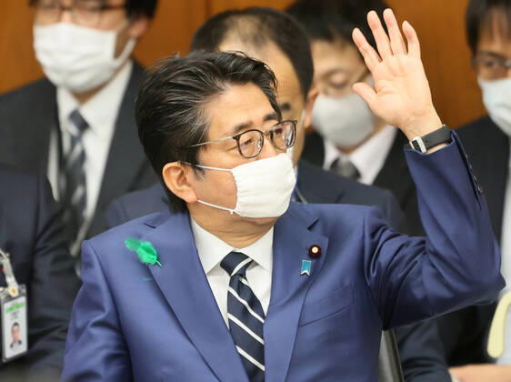 April 17, 2020, Tokyo, Japan - Japanese Prime Minister Shinzo Abe wearing a face mask raises his hand to answer a question at Lower House s health, labour and welfare committee session at the National Diet in Tokyo on Friday, April 17, 2020. Abe expanded a state of emergency across Japan to prevent outbreak of the new coronavirus on April 17.  (125461108)