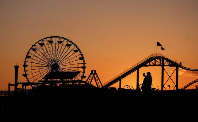 April 17, 2020, Los Angeles, California, U.S: A woman, silhouetted, takes photos during the sunset at Santa Monica Beach Friday April 18, 2020 in Santa Monica, California. Los Angeles U.S. - ZUMAc68_ 20200417_zaf_c68_001 Copyright: xRingoxChiux