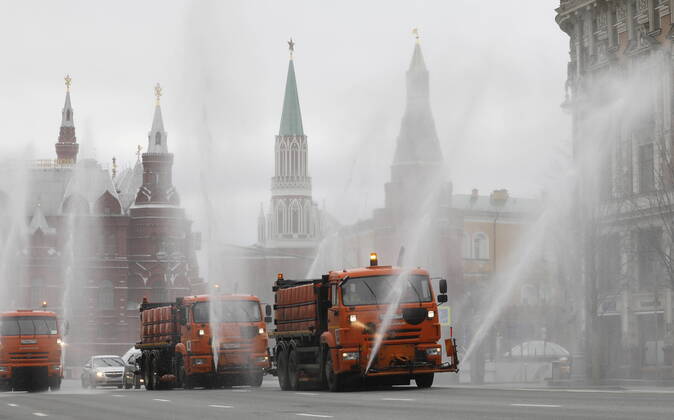 MOSCOW, RUSSIA - APRIL 18, 2020: Utility machines disinfecting the pavement of Tverskaya Street with a special solution recommended by the Russian Federal Service for Surveillance on Consumer Rights Protection and Human Wellbeing (Rospotrebnadzor) amid the COVID-19 coronavirus pandemic. Alexander Shcherbak TASS  TS0D62F5