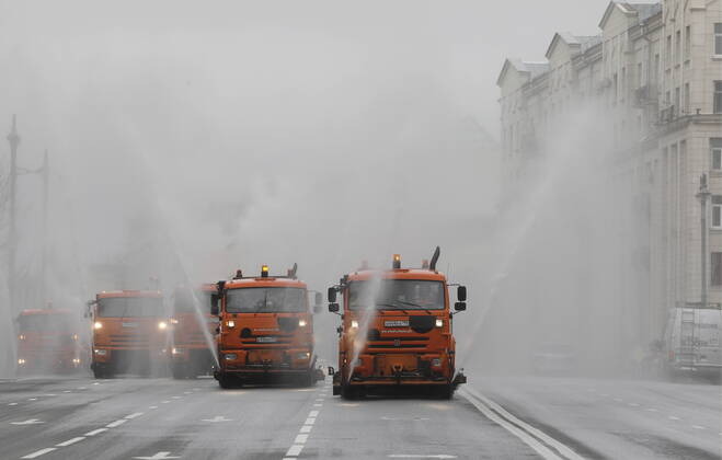 MOSCOW, RUSSIA - APRIL 18, 2020: Utility machines disinfecting the pavement of Tverskaya Street with a special solution recommended by the Russian Federal Service for Surveillance on Consumer Rights Protection and Human Wellbeing (Rospotrebnadzor) amid the COVID-19 coronavirus pandemic. Alexander Shcherbak TASS  TS0D62F7