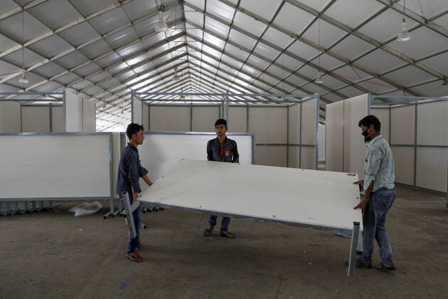 (200418) -- DHAKA, April 18, 2020 (Xinhua) -- Laborers work to convert the International Convention City Bashundhara (ICCB) into a hospital to treat COVID-19 patients in Dhaka, Bangladesh on April 18, 2020. (Str Xinhua) BANGLADESH-DHAKA-COVID-19-DEDICATED-HOSPITAL 