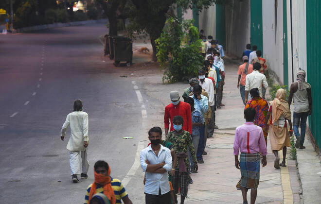 NEW DELHI, INDIA - APRIL 14: Stranded migrant workers and homeless people queue to collect food at Safdarjung Enclave during lockdown, on April 14, 2020 in New Delhi, India. (Photo by Amal KS Hindustan Times ) Government And NGOs Provide Food To Homeless And Poor Amid Lockdown To Prevent Covid-19