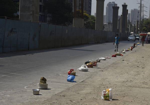 MUMBAI, INDIA - APRIL 14: People keep there utensils and carry bags as their number for food at Laljipada, Kandivali during lockdown due to COVID - 19 Corona Virus pandemic, on April 14, 2020 in Mumbai, India. (Photo by Pramod Thakur Hindustan Times ) Government And NGOs Provide Food To Homeless And Poor Amid Lockdown To Prevent Covid-19