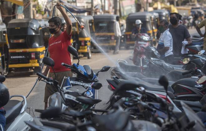 MUMBAI, INDIA APRIL 14: Residence of Juhu spray disinfectants, during the nationwide lockdown, imposed in the wake of the coronavirus pandemic at Juhu, on April 14, 2020 in Mumbai, India. (Photo by Satyabrata Tripathy Hindustan Times ) Sanitization Drive To Curb The Spread Of Coronavirus COVID-19