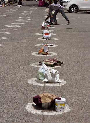 News Bilder des Tages NEW DELHI, INDIA APRIL 18: Belongings are seen placed at circles marked for proper adherence of social distancing during a community feeding session, at R K Ashram, Paharganj, on April 18, 2020 in New Delhi, India. (Photo by Mohd Zakir Hindustan Times ) India Extends Nationwide Coronavirus Lockdown Until May 3