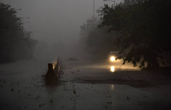 NOIDA, INDIA - APRIL 18: A car on the road at Sector 68, while it rains, on April 18, 2020 in Noida, India. (Photo by Virendra Singh Gosain Hindustan Times ) Heavy Rainfall In Delhi-NCR