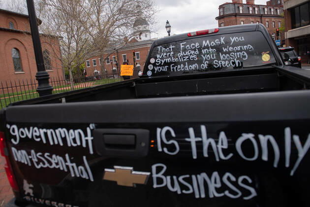 Drivers in vehicle participate in a car protest to reopen Maryland and end the stay at home order imposed during the Coronavirus COVID-19 pandemic, near the state capitol building in Annapolis, Maryland on Saturday, April 18, 2020. Drivers circled Annapolis hoking their horns and calling for Gov. Larry Hogan (R-MD) to end the stay at home order.  WAP20200418335 KEVINxDIETSCH