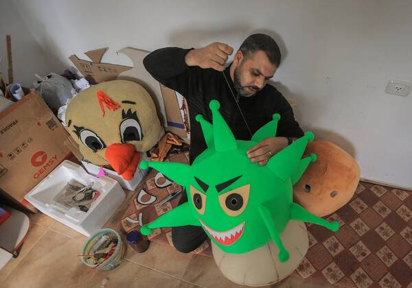 April 18, 2020, Nuseirat Camp, The Gaza Strip, Palestine: A Palestinian man at his workshop in Nuseirat camp in central of the Gaza strip make coronavirus doll to be wear by a clown to awareness kids about the diseases. Nuseirat Camp Palestine - ZUMAq100 20200418_zaa_q100_001 Copyright: xAbedxAlrahmanxAlkahloutx