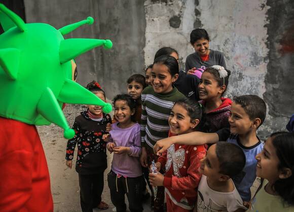 April 18, 2020, Nuseirat Camp, The Gaza Strip, Palestine: Clown wear coronavirus doll in Nuseirat camp in central of the Gaza strip, to awareness kids about the diseases. Nuseirat Camp Palestine - ZUMAq100 20200418_zaa_q100_005 Copyright: xAbedxAlrahmanxAlkahloutx