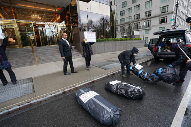 April 18, 2020, New York, NY, USA: Activists with Refuse Fascism deliver body bags props to the Trump International Hotel & Tower New York to protest President TrumpÃ¢â‚¬â ¢s response to COVID-19 on April 18, 2020 in New York. New York USA - ZUMAb148 20200418_zap_b148_106 Copyright: xBryanxSmithx
