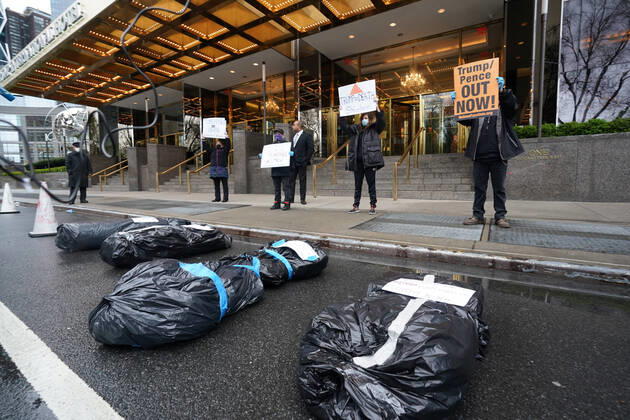 April 18, 2020, New York, NY, USA: Activists with Refuse Fascism deliver body bags props to the Trump International Hotel & Tower New York to protest President TrumpÃ¢â‚¬â ¢s response to COVID-19 on April 18, 2020 in New York. New York USA - ZUMAb148 20200418_zap_b148_119 Copyright: xBryanxSmithx