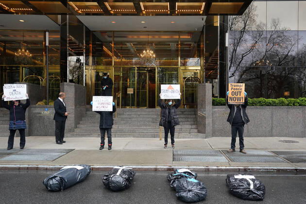 April 18, 2020, New York, NY, USA: Activists with Refuse Fascism deliver body bags props to the Trump International Hotel & Tower New York to protest President TrumpÃ¢â‚¬â ¢s response to COVID-19 on April 18, 2020 in New York. New York USA - ZUMAb148 20200418_zap_b148_148 Copyright: xBryanxSmithx