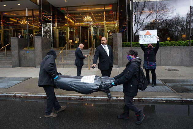 April 18, 2020, New York, NY, USA: Activists with Refuse Fascism deliver body bags props to the Trump International Hotel & Tower New York to protest President TrumpÃ¢â‚¬â ¢s response to COVID-19 on April 18, 2020 in New York. New York USA - ZUMAb148 20200418_zap_b148_173 Copyright: xBryanxSmithx