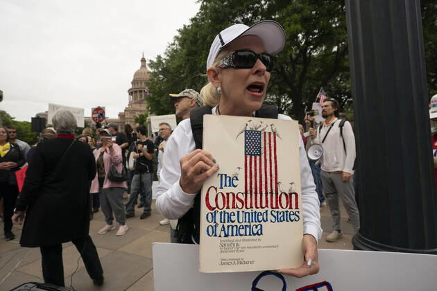 April 18, 2020, Austin, Texas, USA: Claudia Cuchia of Austin speaks to the crowd as a few hundred Texans flaunt social distancing guidelines in an InfoWars inspired rally at the Texas Capitol where founder Alex Jones encourages the crowd with right-wing rhetoric. Gov. Greg Abbott announced Friday relaxed restrictions on business starting next week. Austin USA - ZUMAd150 20200418_znp_d150_019 Copyright: xBobxDaemmrichx