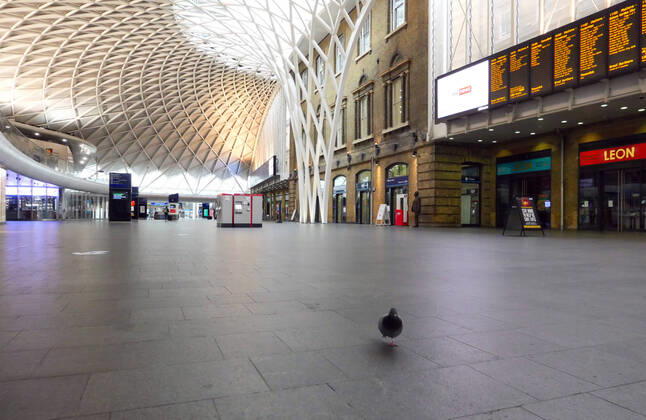 Day Twenty Six of Lockdown in London. A pigeon walks around the concourse at London Kings Cross railway station on a very quiet Saturday as the country is on lockdown due to the COVID-19 Coronavirus pandemic. People are not allowed to leave home except for minimal food shopping, medical treatment, exercise - once a day, and essential work. COVID-19 Coronavirus lockdown, London, UK, on April 18, 2020 