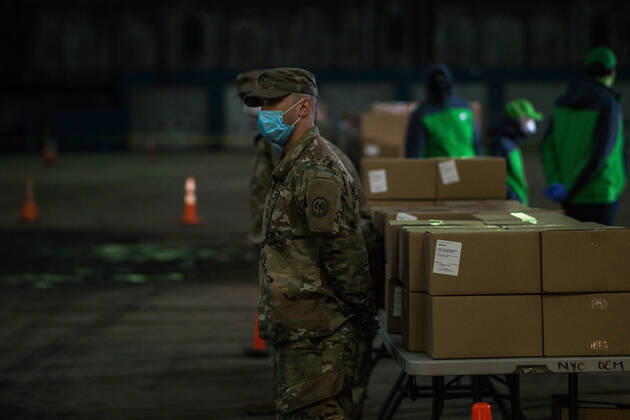 NYC: Mayor de Blasio Press Conference US Army stand guard at the Kingsbridge armory which is being used as a temporary food distribution center during the Covid-19 crisis, and where TLC incensed drivers can pick up meals and delivery to New Yorkers in need. Bronx New York United States Copyright: StevexSanchez