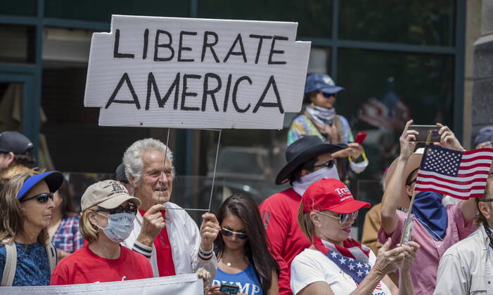 April 18, 2020, San Diego, California, US: Protesters at a Liberate San Diego rally in downtown San Diego on Saturday waved signs and held banners complaining that they wanted the state to lift its stay at home order, a measure meant to reduce the spread of the coronavirus. The event was clearly political, with an overwhelming amount of signs and banners supporting President Trump. San Diego US - ZUMAp23_ 20200418_zaf_p23_003 Copyright: xDavidxPollerx