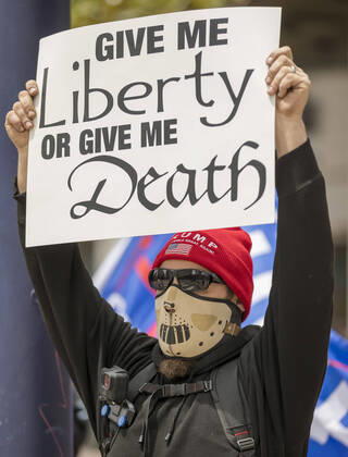 April 18, 2020, San Diego, California, US: Protesters at a Liberate San Diego rally in downtown San Diego on Saturday waved signs and held banners complaining that they wanted the state to lift its stay at home order, a measure meant to reduce the spread of the coronavirus. The event was clearly political, with an overwhelming amount of signs and banners supporting President Trump. San Diego US - ZUMAp23_ 20200418_zaf_p23_030 Copyright: xDavidxPollerx