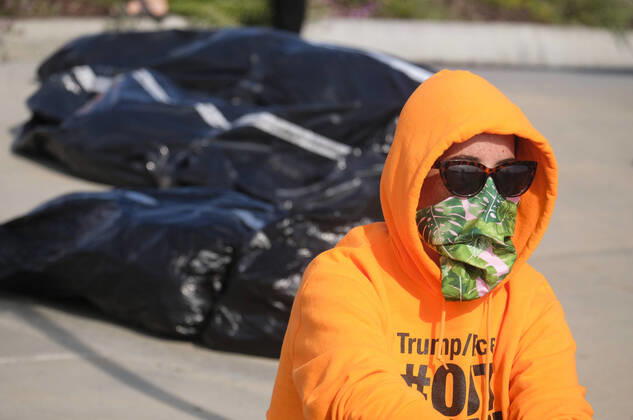 April 18, 2020, Los Angeles, California, U.S: A protester stands as fake body bags are placed at outside Trump National Golf Club Los Angeles in protest against U.S. President Donald Trump s response to the coronavirus disease (COVID-19) pandemic, in Rancho Palos Verdes, California, April 18, 2020. Los Angeles U.S. - ZUMAc68_ 20200418_zaf_c68_012 Copyright: xRingoxChiux
