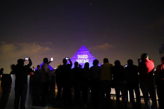 (200418) -- GIZA (EGYPT), April 18, 2020 (Xinhua) -- One of the Giza pyramids is illuminated with words SHARED HERITAGE during the World Heritage Day amid the COVID-19 pandemic in Giza, Egypt, on April 18, 2020. Egypt reported on Saturday 188 new COVID-19 cases, the highest daily increase, bringing the number of confirmed positive cases in the country to 3,032. (Xinhua Ahmed Gomaa) EGYPT-GIZA-PYRAMIDS-COVID-19-WORLD HERITAGE DAY-ILLUMINATION 