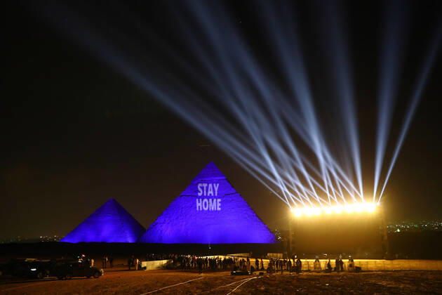 (200418) -- GIZA (EGYPT), April 18, 2020 (Xinhua) -- One of the Giza pyramids is illuminated with words STAY HOME during the World Heritage Day amid the COVID-19 pandemic in Giza, Egypt, on April 18, 2020. Egypt reported on Saturday 188 new COVID-19 cases, the highest daily increase, bringing the number of confirmed positive cases in the country to 3,032. (Xinhua Ahmed Gomaa) EGYPT-GIZA-PYRAMIDS-COVID-19-WORLD HERITAGE DAY-ILLUMINATION 
