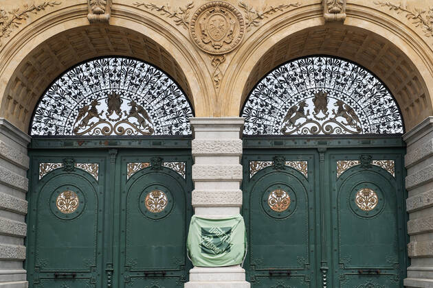 Pilsner Urquell Brewery main gate with a protection face mask is seen on April 18, 2020, in Pilsen, Czech Republic. The brewery bottling beer only into bottles and cans at present. This is due to closed restaurants, pubs and bars due to the coronavirus epidemic. (CTKxPhoto MiroslavxChaloupka) CTKPhotoP202004180314901 cha007