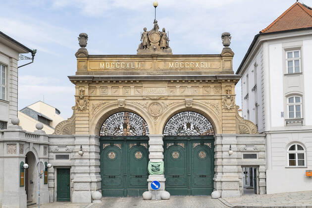 Pilsner Urquell Brewery main gate with a protection face mask is seen on April 18, 2020, in Pilsen, Czech Republic. The brewery bottling beer only into bottles and cans at present. This is due to closed restaurants, pubs and bars due to the coronavirus epidemic. (CTKxPhoto MiroslavxChaloupka) CTKPhotoP202004180319901 cha006