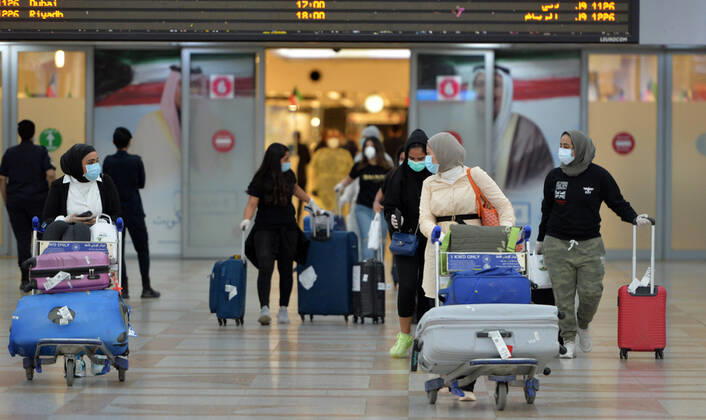 (200419) -- FARWANIYA GOVERNORATE, April 19, 2020 -- Kuwaiti passengers walk out of the arrival hall of airport after they were evacuated from abroad, at Kuwait International Airport in Farwaniya Governorate, Kuwait, April 19, 2020. Kuwait launched on Sunday its major airlift to bring home Kuwaitis stranded abroad due to the coronavirus pandemic. (Photo by Xinhua) KUWAIT-FARWANIYA GOVERNORATE-COVID-19-AIRPORT-REPATRIATION Asad 