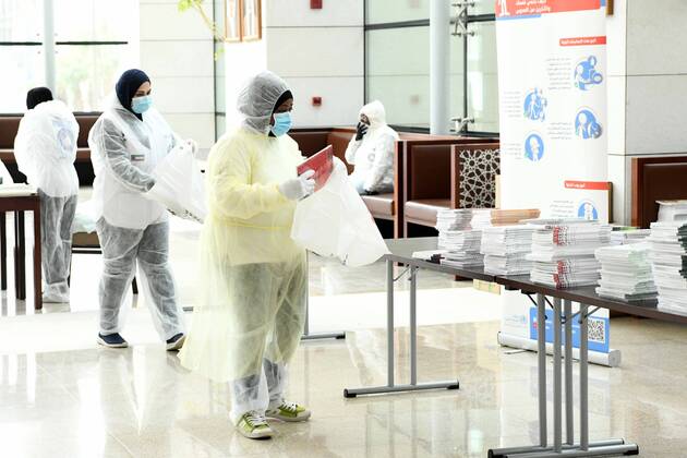 (200419) -- KUWAIT CITY, April 19, 2020 (Xinhua) -- Workers prepare publications to be distributed to quarantined people in the National Library of Kuwait in Kuwait City, Kuwait, April 19, 2020. Kuwaiti National Council for Culture, Arts and Letters (NCCAL), in cooperation with Kuwait Red Crescent Society, prepared on Sunday cultural baskets containing a number of publications to distribute to quarantined people due to the coronavirus for their recreation and leisure time reading. (Photo by Ghazy Qaffaf Xinhua) KUWAIT-KUWAIT CITY-CORONAVIRUS-PUBLICATION DISTRIBUTION 