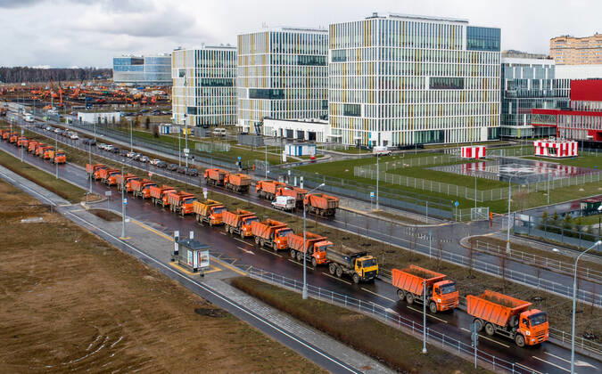 MOSCOW, RUSSIA - APRIL 19, 2020: A column of trucks moves in the direction from the construction site of a new building of the Novomoskovsky multipurpose medical center for patients with suspected COVID-19 coronavirus infection. Sergei Bobylev TASS  TS0D65F0