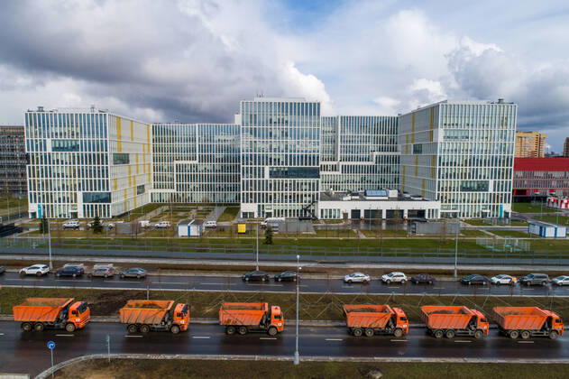 MOSCOW, RUSSIA - APRIL 19, 2020: A column of trucks moves in the direction from the construction site of a new building of the Novomoskovsky multipurpose medical center for patients with suspected COVID-19 coronavirus infection. Sergei Bobylev TASS  TS0D65F2