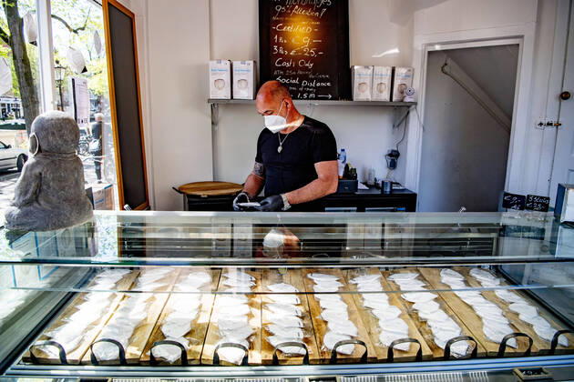 April 19, 2020, Amsterdam, Netherlands: A man at a store while wearing a face mask as a protective measure against the spread of Coronavirus at the store..Opening a face mask store during the corona crisis is very critical. Certified surgical face masks would be sold for 9 euros each and the store can only take cash. Amsterdam Netherlands - ZUMAs197 20200419_zaa_s197_033 Copyright: xRobinxUtrechtx