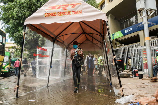 April 19, 2020, Nairobi, Kenya: A passenger walks through a sanitiser spray booth that disinfects the whole body at Kencom Bus Stop before boarding public transport to their various destinations as a preventive measure against the spread of Coronavirus..President Uhuru Kenyatta on March 25, 2020 imposed a dusk-to-dawn 21 day curfew from (7pm-5am) that took effect on Friday, March 26, 2020 in order to curb the spread of COVID-19. Kenya has so far recorded 270 cases of the Coronavirus, 67 recoveries and 14 deaths. Nairobi Kenya - ZUMAs197 20200419_zaa_s197_059 Copyright: xDennisxSigwex